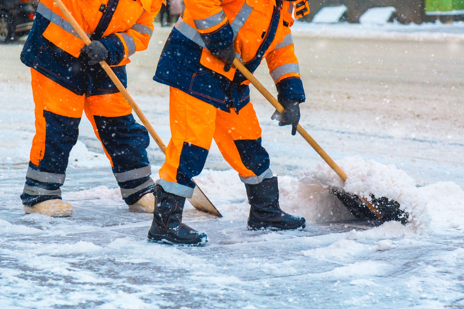 Communal services workers sweep snow from road in winter, Cleaning city streets and roads during snowstorm. Moscow, Russia.